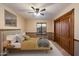 Bedroom with two-tone walls, carpet, and a window complemented by a ceiling fan for optimal air circulation at 1001 N Peppertree Dr, Gilbert, AZ 85234