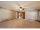 Empty bedroom features a ceiling fan and a view of the stairs through an open doorway at 1001 N Peppertree Dr, Gilbert, AZ 85234