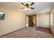Bedroom features carpet, a ceiling fan, mounted tv, and access to an en-suite bathroom for added convenience at 1001 N Peppertree Dr, Gilbert, AZ 85234