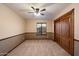 Bedroom featuring a ceiling fan, carpet, a window with wooden blinds, and a closet with wooden doors at 1001 N Peppertree Dr, Gilbert, AZ 85234