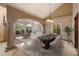 Elegant dining room open to the living space, featuring neutral paint, columns and travertine flooring at 1001 N Peppertree Dr, Gilbert, AZ 85234