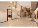 Grand foyer showcasing tile flooring, an open staircase, and views into the adjacent living spaces at 1001 N Peppertree Dr, Gilbert, AZ 85234