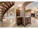 Elegant foyer boasting travertine flooring, a staircase, and a wet bar niche with granite countertops at 1001 N Peppertree Dr, Gilbert, AZ 85234