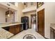 Functional kitchen featuring granite countertops, dark wood cabinetry, and stainless steel appliances at 1001 N Peppertree Dr, Gilbert, AZ 85234