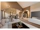 Inviting living space with open archways, travertine flooring, and a staircase leading to the second level at 1001 N Peppertree Dr, Gilbert, AZ 85234