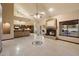 Open-concept living space boasting tile floors, a fireplace, and seamless flow to the kitchen at 1001 N Peppertree Dr, Gilbert, AZ 85234