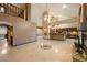 Spacious living area featuring high ceilings and seamless transitions to the kitchen and upper level at 1001 N Peppertree Dr, Gilbert, AZ 85234