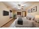 Main bedroom showcasing a comfortable bed, ceiling fan, and a window with natural light at 1001 N Peppertree Dr, Gilbert, AZ 85234
