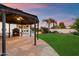 Outdoor patio with a cozy fireplace, gazebo, and lush green lawn, ideal for gatherings at 1001 N Peppertree Dr, Gilbert, AZ 85234