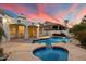 Inviting backyard pool with lush landscaping and covered patio for outdoor relaxation at 1001 N Peppertree Dr, Gilbert, AZ 85234