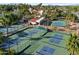 Aerial view of tennis and pickleball courts shaded by swaying palm trees, perfect for an active lifestyle at 1001 N Peppertree Dr, Gilbert, AZ 85234