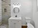 Updated bathroom with a modern gray tile shower, new fixtures, and a vanity at 1019 N 62Nd Ave, Phoenix, AZ 85043