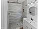 Modern bathroom features a gray tile shower, modern fixtures, and vanity at 1019 N 62Nd Ave, Phoenix, AZ 85043