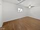 Spacious bedroom with wood-look tile flooring, and a modern ceiling fan at 1019 N 62Nd Ave, Phoenix, AZ 85043