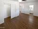 Open bedroom with wood-look tile flooring leading to a view of a bathroom at 1019 N 62Nd Ave, Phoenix, AZ 85043