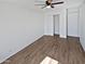 Bright bedroom features a ceiling fan, closet, and wood-look tile flooring at 1019 N 62Nd Ave, Phoenix, AZ 85043