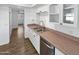 Modern kitchen features white cabinets, stainless steel appliances, and a stainless steel double sink at 1019 N 62Nd Ave, Phoenix, AZ 85043