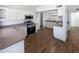 Spacious kitchen with white cabinets, stainless steel appliances, and wood-look flooring at 1019 N 62Nd Ave, Phoenix, AZ 85043