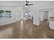 Bright, open living space with wood-look tile flooring, ceiling fan, and access to the kitchen at 1019 N 62Nd Ave, Phoenix, AZ 85043