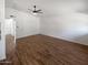 Open-concept living room showcasing wood-look flooring, neutral walls, and a modern ceiling fan at 1019 N 62Nd Ave, Phoenix, AZ 85043