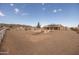 Expansive backyard features a desert landscape, gravel, white fencing and mature trees at 10539 W Tamara Dr, Casa Grande, AZ 85193