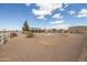 Wide backyard features mature trees, white fencing, desert landscaping, gravel and solar panels at 10539 W Tamara Dr, Casa Grande, AZ 85193