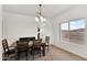 Bright dining room with a wood table set and a window view at 10539 W Tamara Dr, Casa Grande, AZ 85193