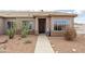 Charming front yard featuring desert landscaping with cacti, decorative pots, and a paved walkway at 10539 W Tamara Dr, Casa Grande, AZ 85193