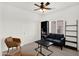 Stylish living room featuring a black sofa, accent chairs, a coffee table and a decorative ladder shelf at 10539 W Tamara Dr, Casa Grande, AZ 85193