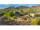 Stunning aerial view of the home with a pool, desert landscaping, and scenic mountain backdrop at 10875 E Mirasol Cir, Scottsdale, AZ 85255