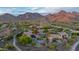 Stunning aerial view of a home featuring a pool, solar panels, and breathtaking mountain views at 10875 E Mirasol Cir, Scottsdale, AZ 85255