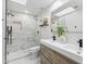 Modern bathroom with a double sink vanity, walk-in shower and clean white finishes at 10875 E Mirasol Cir, Scottsdale, AZ 85255