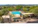 A pristine community pool offers clear blue water and relaxing lounge chairs surrounded by desert landscaping at 10875 E Mirasol Cir, Scottsdale, AZ 85255