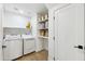 Clean laundry room with a washer and dryer and storage shelving at 10875 E Mirasol Cir, Scottsdale, AZ 85255