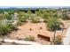 Community Arabian Library sign surrounded by desert landscape and a view of the building and parking lot at 10875 E Mirasol Cir, Scottsdale, AZ 85255