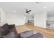 Second-floor living room with a fan, railing, and comfortable sofa at 10875 E Mirasol Cir, Scottsdale, AZ 85255