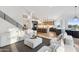 Bright, open-concept living room featuring a modern kitchen, staircase and comfortable seating area at 10875 E Mirasol Cir, Scottsdale, AZ 85255
