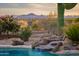 Backyard pool features a unique rock waterfall feature at 10875 E Mirasol Cir, Scottsdale, AZ 85255