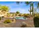Serene backyard with a pool surrounded by desert plants and landscape, and outdoor seating at 10875 E Mirasol Cir, Scottsdale, AZ 85255