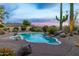 Desert oasis featuring a beautiful freeform pool, lush landscaping, and captivating mountain views at 10875 E Mirasol Cir, Scottsdale, AZ 85255