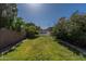 Lush backyard featuring manicured lawn, privacy fence, and glimpses of a refreshing pool area at 1109 E San Pedro Ave, Gilbert, AZ 85234