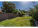 Spacious backyard with well-maintained lawn, mature trees, and privacy fence, ideal for outdoor activities at 1109 E San Pedro Ave, Gilbert, AZ 85234