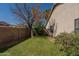 Green backyard with stone border, brick wall, and mature landscaping at 1109 E San Pedro Ave, Gilbert, AZ 85234