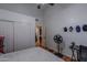 White bedroom features a fan, closet, and simple furnishings, offering a clean and serene space at 1109 E San Pedro Ave, Gilbert, AZ 85234