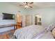 This bedroom has light colored walls, hard wood floors, ceiling fan, and en suite bathroom access at 1109 E San Pedro Ave, Gilbert, AZ 85234