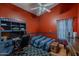 This bedroom features hardwood floors, a ceiling fan, and built in shelf space at 1109 E San Pedro Ave, Gilbert, AZ 85234