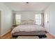 Bright, airy bedroom with neutral decor, hardwood floors, and a large bed at 1109 E San Pedro Ave, Gilbert, AZ 85234