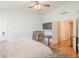 This bright bedroom features light colored walls, hardwood floors, ceiling fan, and backyard access at 1109 E San Pedro Ave, Gilbert, AZ 85234