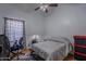 Bright bedroom with natural light, featuring a ceiling fan and simple decor at 1109 E San Pedro Ave, Gilbert, AZ 85234