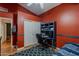 Cozy bedroom with red accent wall, desk, and closet, creating an inviting space at 1109 E San Pedro Ave, Gilbert, AZ 85234